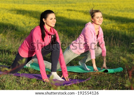 yoga Girls on the background field of yellow flowers. yoga instructor shows poses