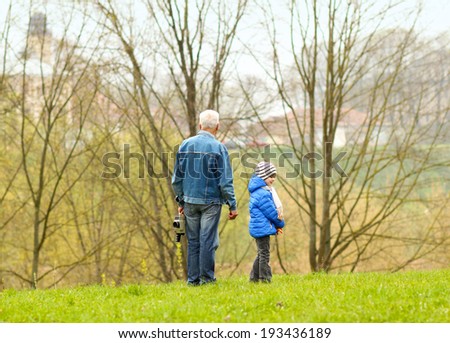 Grandfather helping his grandson to make a film