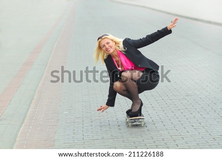 Senior business woman having fun on a skateboard outdoors