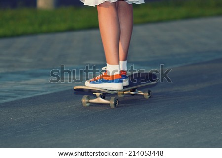 teenager legs in sneakers with skateboard at sunset. Conceptual photo. Urban lifestyle shot.