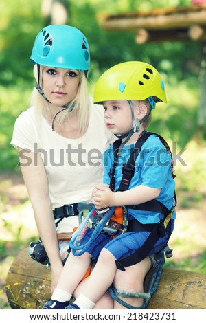 Mom and small child son in a special outfit rest and drink water.