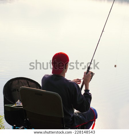 Fisherman fishing. Feeder sport. A fisherman catches a fish in the morning at sunrise in the fog