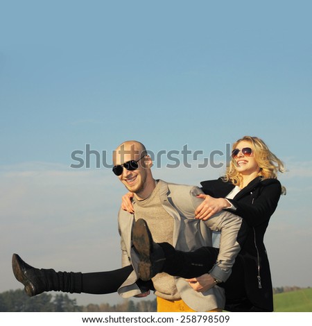 The couple has emotional and crazy fun outdoors. young beautiful couple having fun outdoors. Young happy couple outdoor portrait.