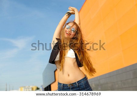 funny cute smiling woman. Beautiful laughing girl . Free woman enjoying freedom feeling happy. Hipster girl showing happy positive emotions on the background of the shopping center