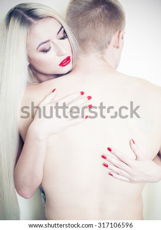 blonde and a man passionate embrace. Beautiful girl in the image of albino with red lips. Art beauty face. art photography with red lips and nails. art Photography