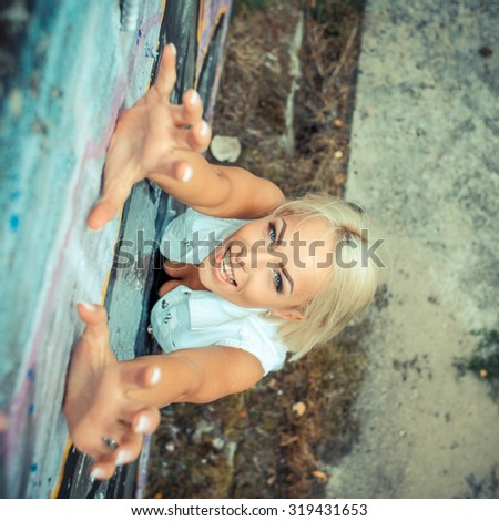 Positive hipster girl. portrait of a beautiful young hipster girl which climbs upwards. view from above