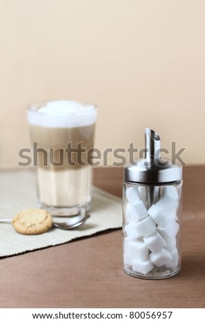 latte macciato with sugar dispenser