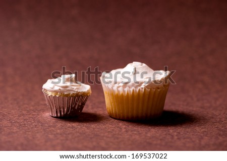 two Vanilla muffins with sweet white chocolate cream topping