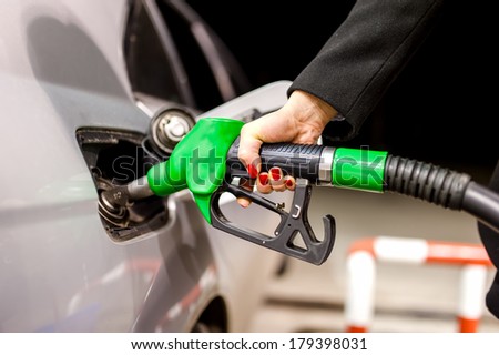 Pumping gas at petrol station
