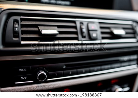 modern car interior with close-up of ventilation system holes and air conditioning. Concept wallpaper for auto air conditioning and climate control