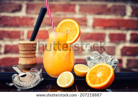 refreshment orange lemonade drink served in jug. Ingredients of orange lemonade with vintage effect