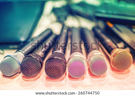 collection of microphones and dj equipment at a concert, in backstage