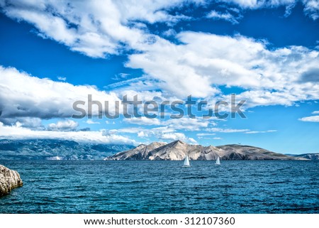 Island seaside or ocean landscape, travel image of boats, clear sky and water. Cliffs and ocean landscape