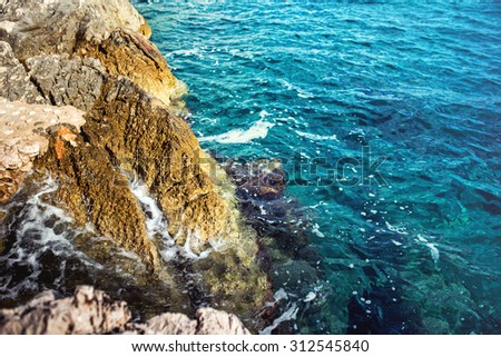 Sea landscape wallpaper background with island cliffs and ocean hitting rocks