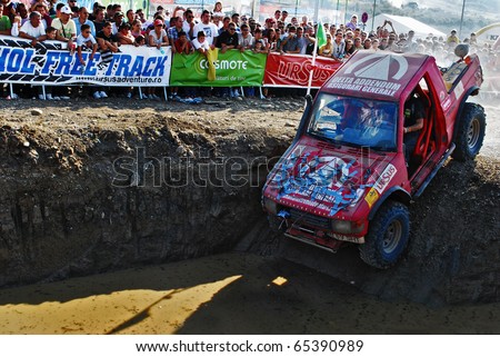 CLUJ-NAPOCA, ROMANIA - SEPT. 26::  - An off-road car falls into water in a specially designed hole/pit on Sept. 26, 2009 at \