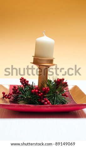 Christmas tree and candle decorations with gift box over golden background