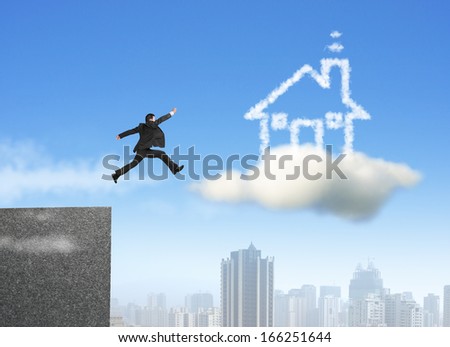 Businessman running and jumping on cloud dream house with city background
