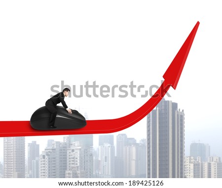 Riding computer mouse on growing arrow with city buildings background