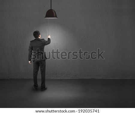Businessman turn on the light indoor
