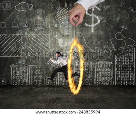 Man jumping through fire circle hand holding with doodles wall background