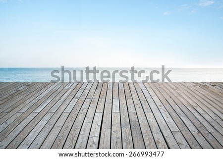 Old vertical striped wooden terrace with sky sea background