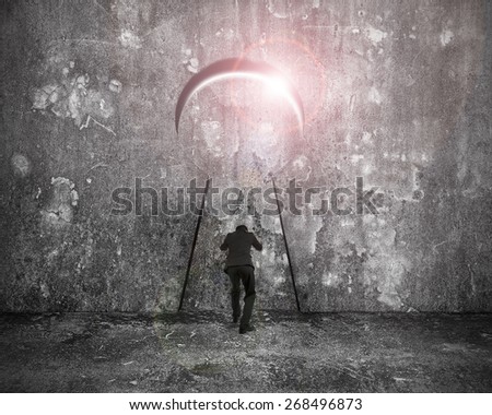 Businessman pushing keyhole door with bright sunlight on mottled concrete wall background