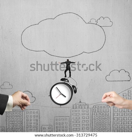 Two hands pulling rope with businessman balancing on alarm clock, on hand-drawn doodles concrete wall background.