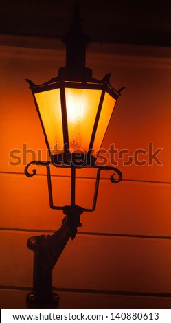 Old street lamp light on the wall at night. Tallinn, Estonia