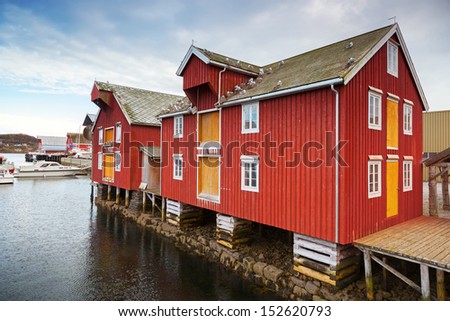Red and yellow wooden coastal houses in Norwegian fishing village. Rorvik, Norway