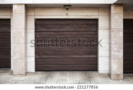 Brown garage gate in living house wall