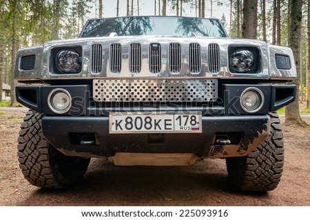 SAINT-PETERSBURG, RUSSIA - OCTOBER 12, 2014: black Hummer H2 car stands on dirty country road in Russia. Front view