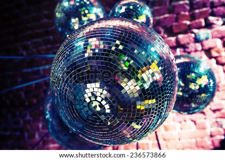 Colorful disco party background with mirror balls reflecting lights