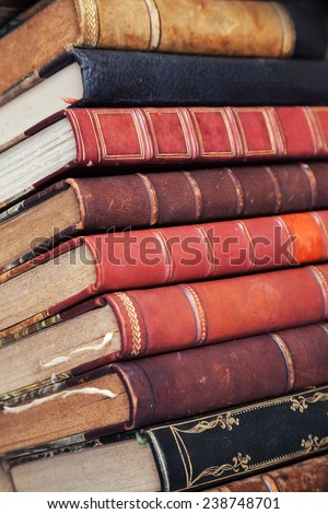 Big stack of old books with colorful leather covers