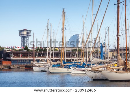 Barcelona, Spain - August 26, 2014: Vista port landscape with Montjuic cable car tower. Yachts and sailing boats are moored in marina