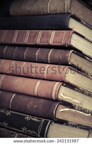 Big stack of old books with leather covers, vintage toned photo with filter effect