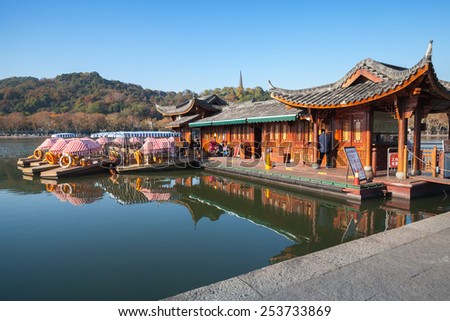 Hangzhou, China - December 5, 2014: Chinese recreation boats are moored on the West Lake coast. Famous park in Hangzhou city