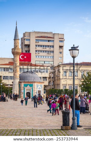 Izmir, Turkey - February 5, 2015: Izmir, Turkey - February 5, 2015: Konak Square with tourists walking near the ancient mosque