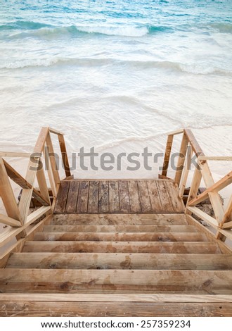 Empty wooden stairs goes down to the sea