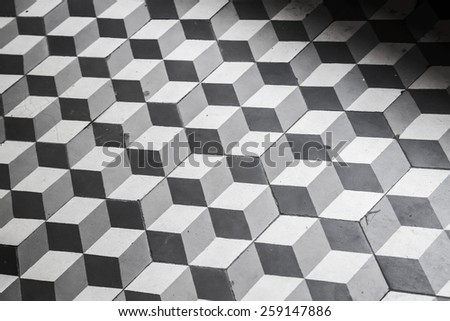 Old black and white tiling on the floor, cubic pattern, retro style