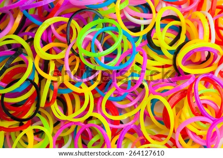 Macro photo texture of small round colorful rubber bands for making rainbow loom bracelets