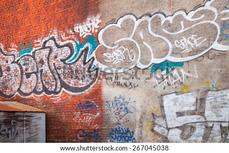 Saint-Petersburg, Russia - April 3, 2015: Urban brick wall with grungy graffiti. Vasilievsky island, Central old part of St. Petersburg city
