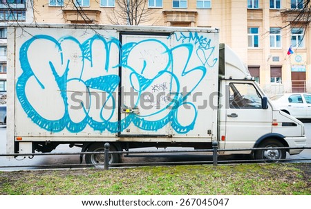 Saint-Petersburg, Russia - April 3, 2015: White van with blue graffiti. Vasilievsky island, Central old part of St. Petersburg city