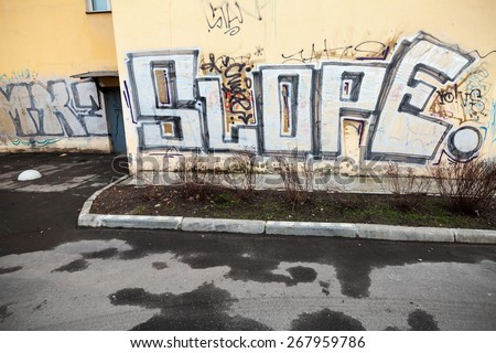 Saint-Petersburg, Russia - April 3, 2015: Graffiti fragment with Slope text on the yellow wall. Vasilievsky island, Central old part of St. Petersburg city
