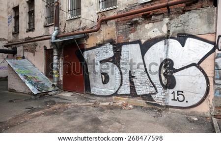 Saint-Petersburg, Russia - April 7, 2015: Graffiti with abstract text on old outdoor walls. Vasilievsky island, Central old part of St. Petersburg city