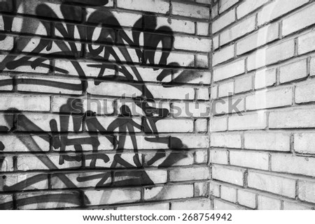 Saint-Petersburg, Russia - April 7, 2015: Abstract graffiti fragment on gray brick wall, empty urban interior fragment
