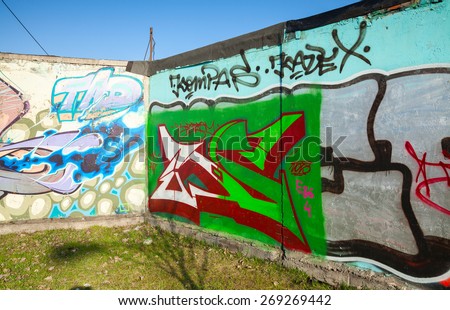 Saint-Petersburg, Russia - April 6, 2015: Corner with colorful graffiti, chaotic patterns and text  on old gray concrete walls