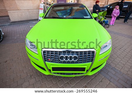 Saint-Petersburg, Russia - April 11, 2015: Bright green sporty styled Audi S8 car stands parked on the street. Wide angle closeup photo, front view