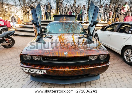 Saint-Petersburg, Russia - April 11, 2015: Dodge challenger with aggressive street race design stands with open doors, front view