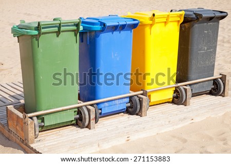 Colorful plastic containers in a row for separate garbage collection