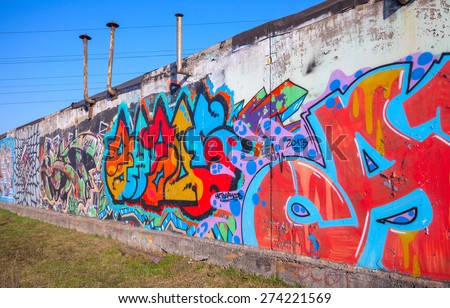 Saint-Petersburg, Russia - April 6, 2015: Colorful abstract text graffiti patterns painted on old gray concrete garage wall